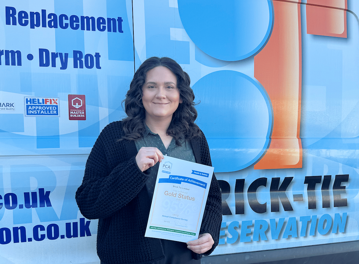 Kirstie Park with Brick-Tie safety audit certificate by a Brick-Tie van.